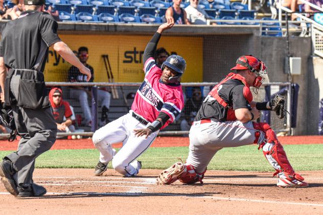 Paul McIntosh of the Pensacola Blue Wahoos reaches for home plate ahead of the tag