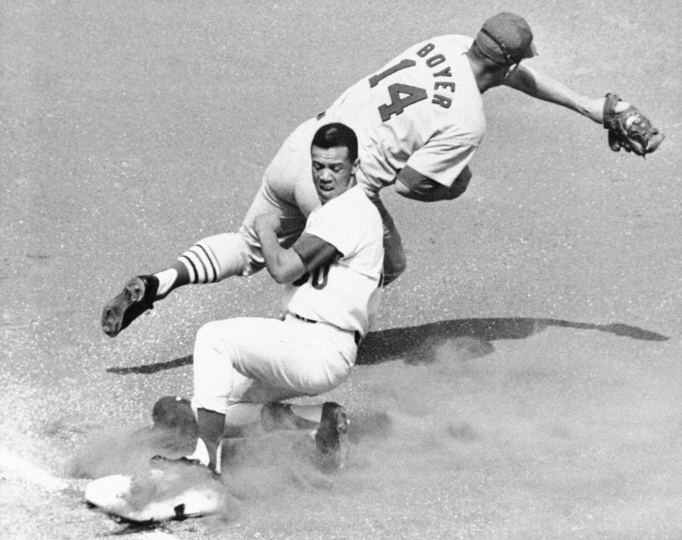 Dodgers' Maury Wills slides safely into third as St. Louis Cardinals' Ken Boyer takes the throw in 1965.
