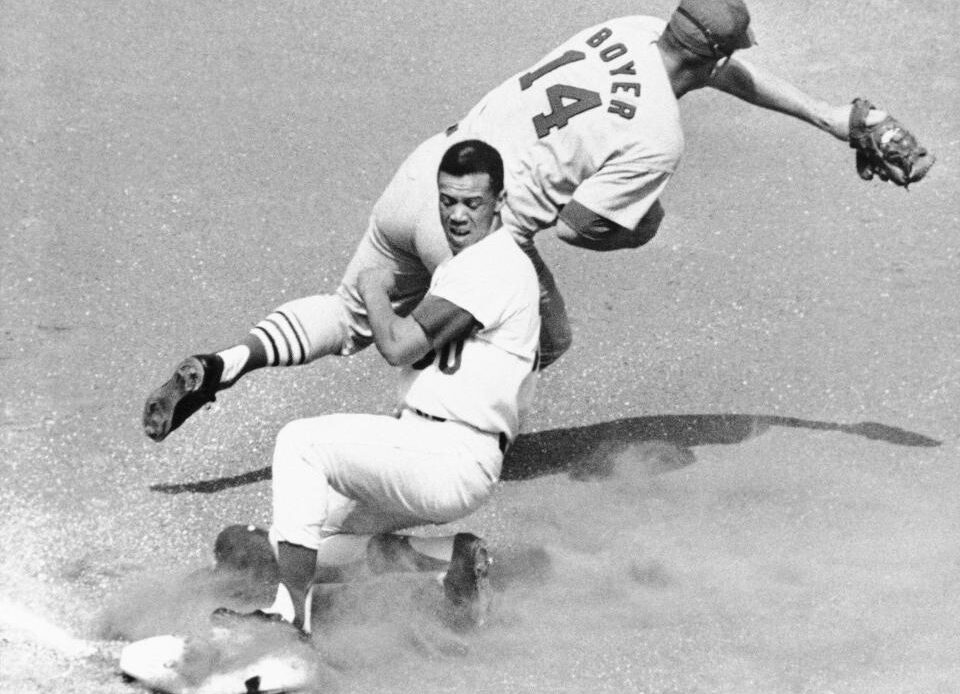 The Dodgers' Maury Wills is safe at third base as the Cardinals' Ken Boyer takes the throw during a game in 1965.