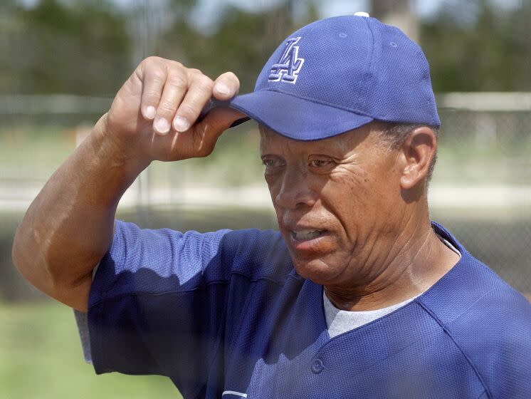 Dodgers bunting and base running coordinator Maury Wills adjusts his cap during spring training at Dodgertown