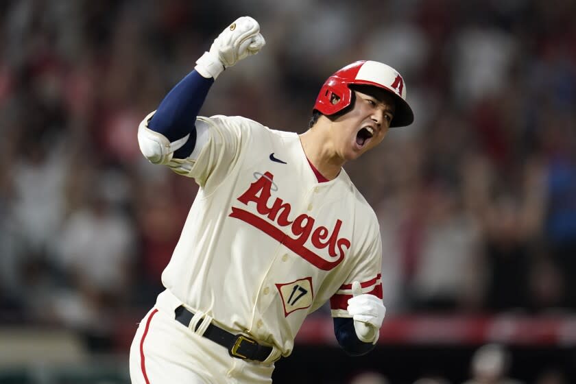 Los Angeles Angels designated hitter Shohei Ohtani (17) reacts as he runs the bases after hitting a home run during the sixth inning of a baseball game against the New York Yankees in Anaheim, Calif., Wednesday, Aug. 31, 2022. David Fletcher and Mike Trout also scored. (AP Photo/Ashley Landis)
