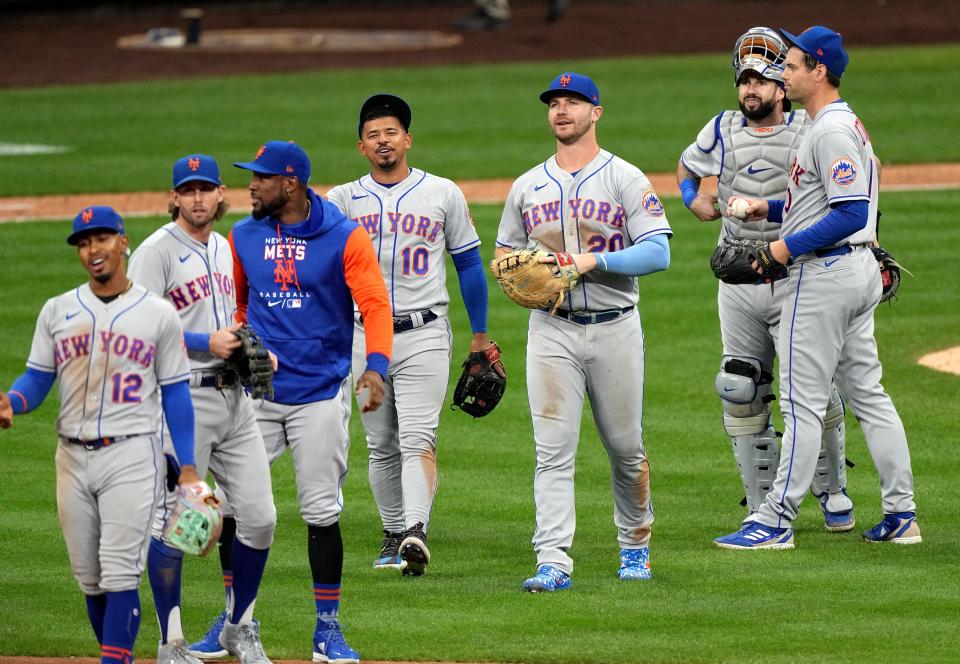 The New York Mets celebrate clinching a playoff berth after beating the Milwaukee Brewers 7-2.