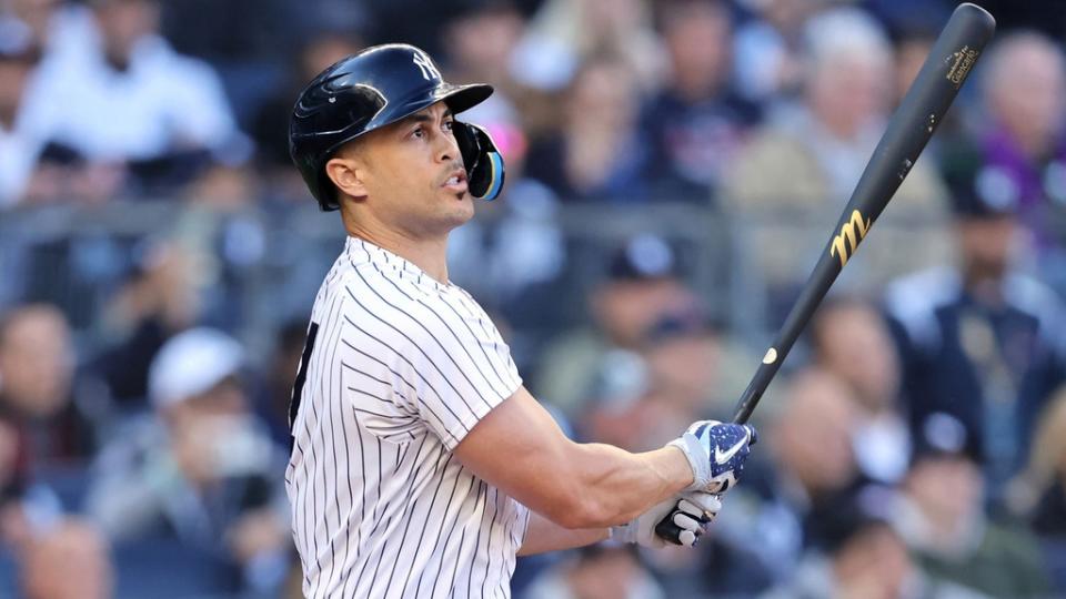 Oct 18, 2022; Bronx, New York, USA; New York Yankees designated hitter Giancarlo Stanton (27) hits a three-run home run against the Cleveland Guardians during the first inning in game five of the ALDS for the 2022 MLB Playoffs at Yankee Stadium.