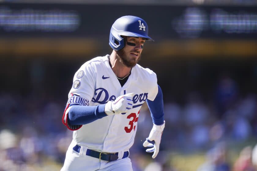 Los Angeles Dodgers' Cody Bellinger runs toward second base after hitting a double
