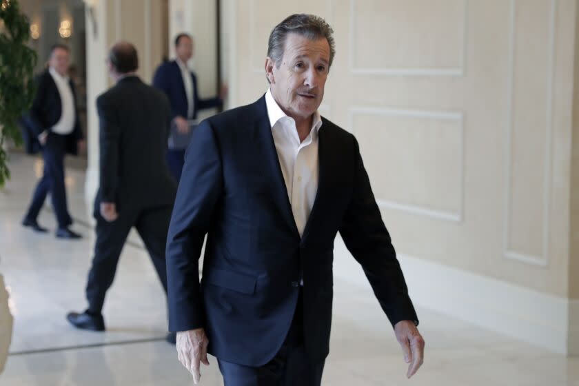 Arte Moreno, owner of the Los Angeles Angels, leaves a meeting during MLB baseball owners meetings, Thursday, Feb. 6, 2020, in Orlando, Fla. (AP Photo/John Raoux)