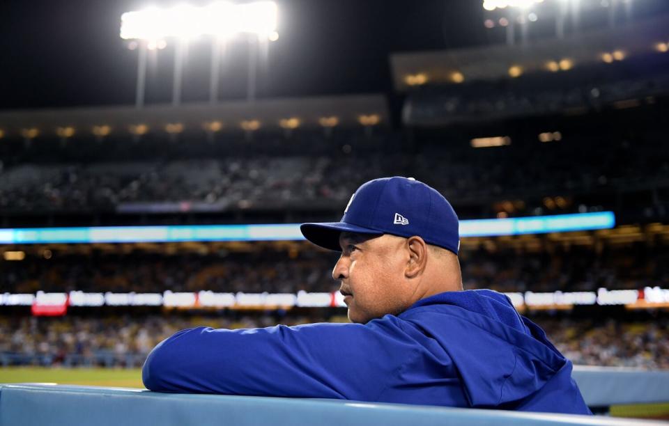 Dodgers manager Dave Roberts watches from the dugout during a game against the Colorado Rockies in October.