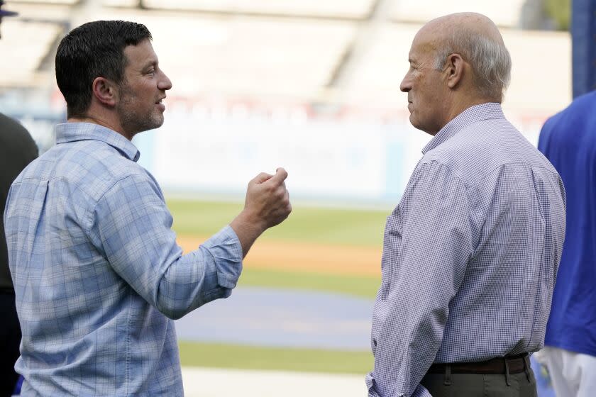 Los Angeles Dodgers President of Baseball Operations Andrew Friedman, left, talks with co-owner Stan Kasten.