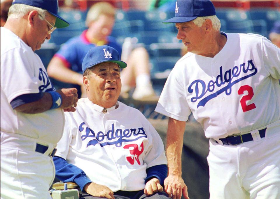 Dodgers manager Tommy Lasorda, right, talks with Hall of Famer Roy Campanella, center, and Ralph Avila, vice president of Campo Las Palmas, the Dodgers' baseball academy in the Dominican Republic in 1993.