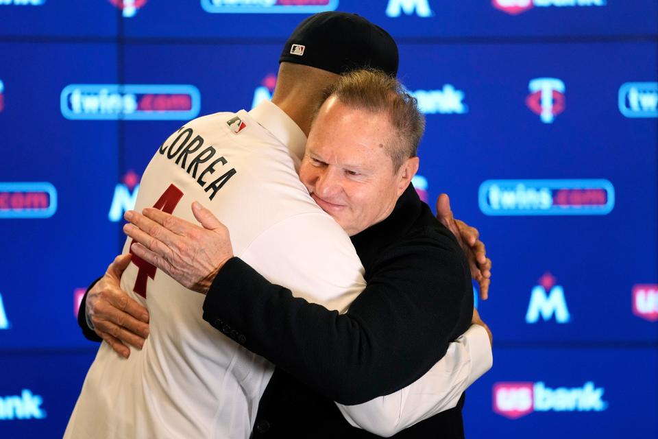 Carlos Correa and Scott Boras hug at the shortstop's press conference in Minneapolis.