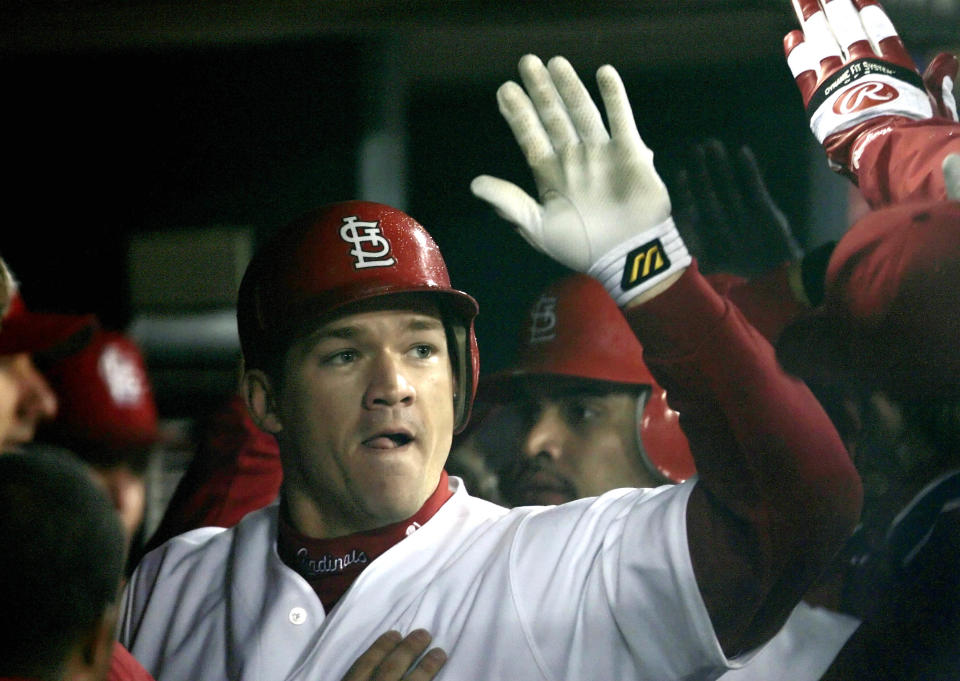 Scott Rolen celebrates with his St. Louis Cardinals teammates after hitting a two-run home run off of Houston Astros pitcher Chad Harville, during the fifth inning in Game 2 of the National League Championship Series in St. Louis, October 14, 2004. REUTERS/Mike Blake  JPS/GN