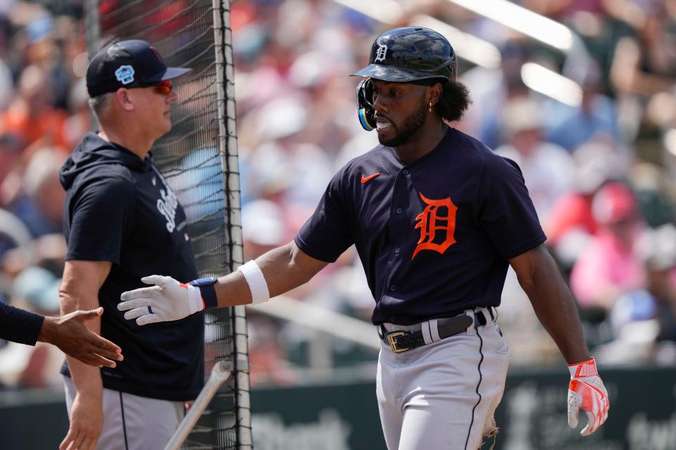 Detroit Tigers Akil Baddoo is greeted after scoring on an RBI double by Riley Greene in the third inning of a spring training baseball game against the Minnesota Twins in Fort Myers, Fla., Sunday, March 5, 2023. (AP Photo/Gerald Herbert)
