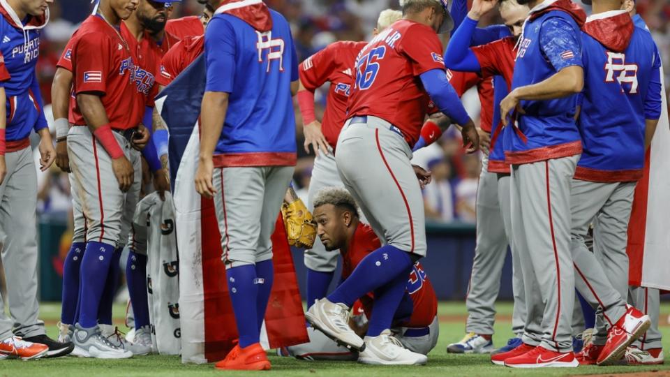 Mar 15, 2023; Miami, Florida, USA; Puerto Rico relief pitcher Edwin Diaz (39) looks on while sitting on the field after an apparent leg injury during the team celebration after winning the game against Dominican Republic at LoanDepot Park.