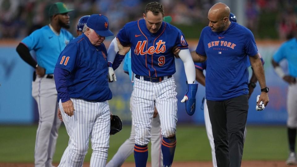 Mar 17, 2023; Port St. Lucie, Florida, USA; New York Mets center fielder Brandon Nimmo (9) walks back to the dugout with the assistance of manager Buck Showalter (11) and a trainer in the fifth inning against the Miami Marlins at Clover Park.