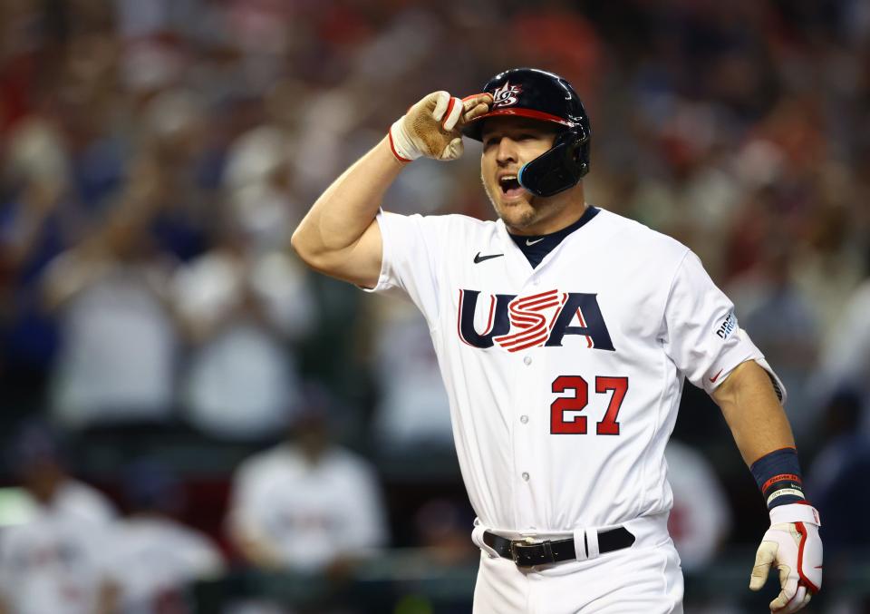 Mike Trout celebrates after hitting a three run home run in the first inning against Canada.