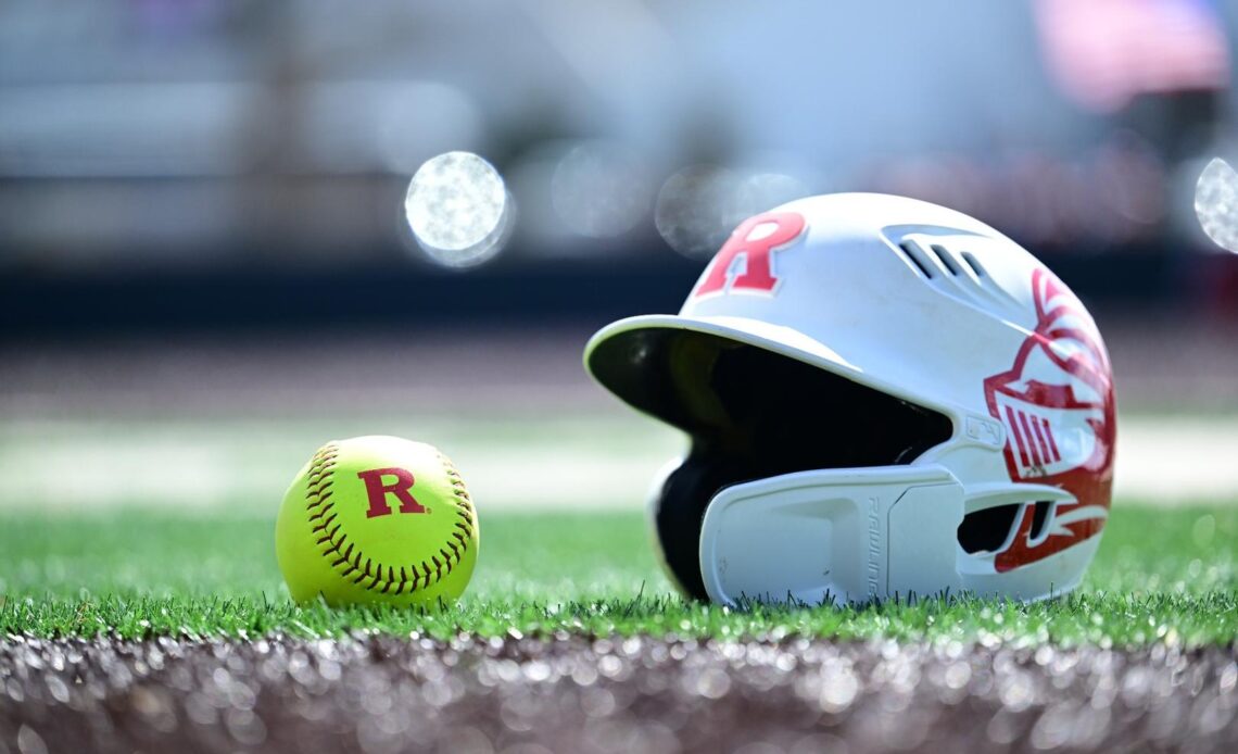 Rutgers Softball helmet and Block R softball on the turf at the Rutgers Softball Complex