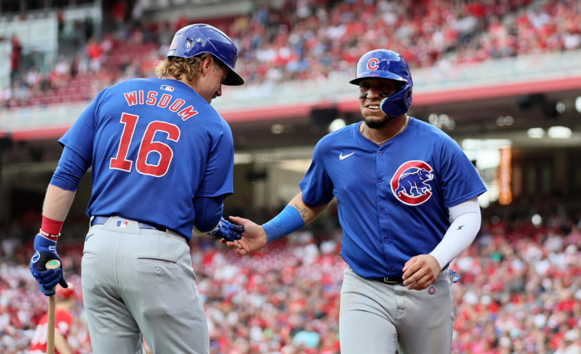 Happ launches 2-run homer and Cubs pound out 17 hits in 13-4 rout of Reds