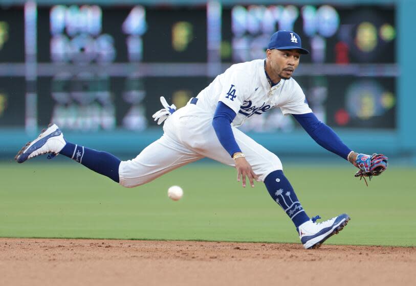 LOS ANGELES CALIFORNIA CALIFORNIA-Dodgers shortstop Mookie Betts can't make the play on a single by Rangers Nathaniel Lowe in the second inning at Dodgers Stadium Tuesday. (Wally Skalij/Los Angeles Times)