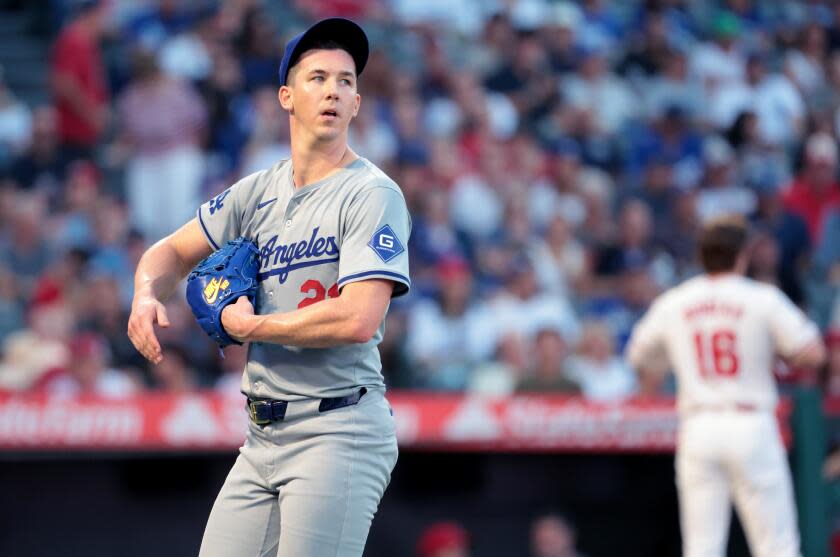 Dodgers pitcher Walker Buehler looks across the field as he walks off the mound during a game against the Angels