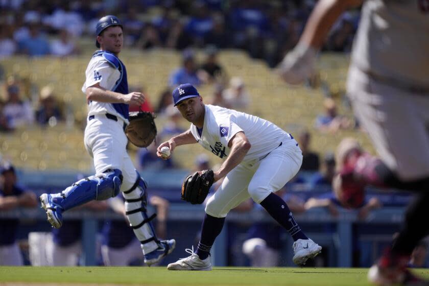 Los Angeles Dodgers starting pitcher Jack Flaherty, center, throws out Cleveland Guardians' Josh Naylor.