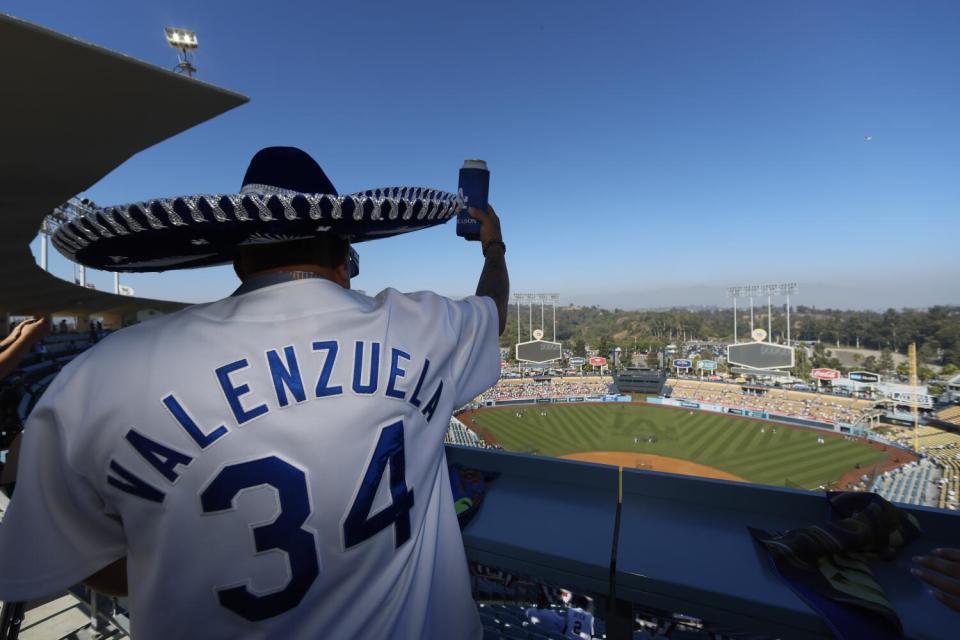 Gonzalo Gonzalez wears a blue sombrero to honor late Dodgers pitcher Fernando Valenzuela.