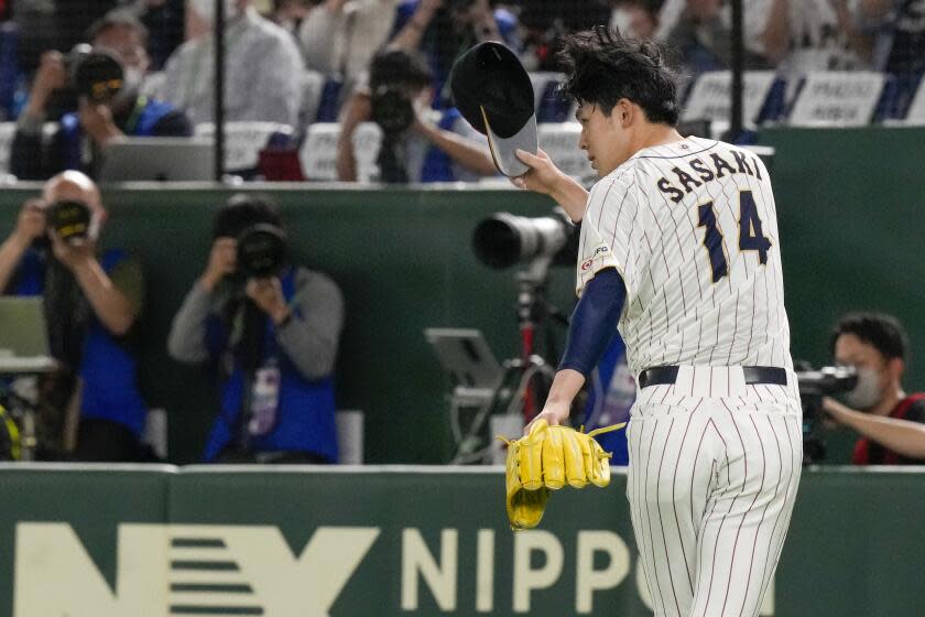 Pitcher Roki Sasaki of Japan gestures to the crowd as he leaves the field during their Pool B game against Czech Republic at the World Baseball Classic at the Tokyo Dome, Japan, Saturday, March 11, 2023. (AP Photo/Eugene Hoshiko)