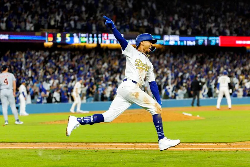 Mookie Betts celebrates after hitting a walk-off home run in the 10th inning against the Detroit Tigers at Dodger Stadium.