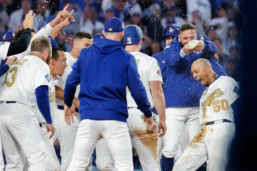 Dodgers shortstop Mookie Betts, far right, celebrates with teammates after hitting a walk-off home run at Dodger Stadium.