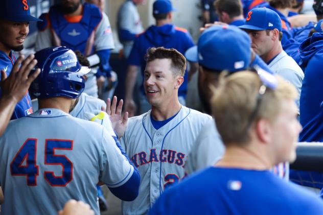 Jared Young receives congratulations in the Syracuse Mets dugout